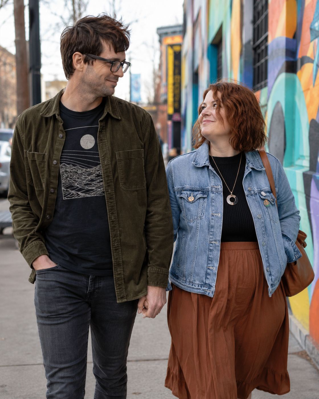 Illustrative photo of a couple walking past a colorful mural