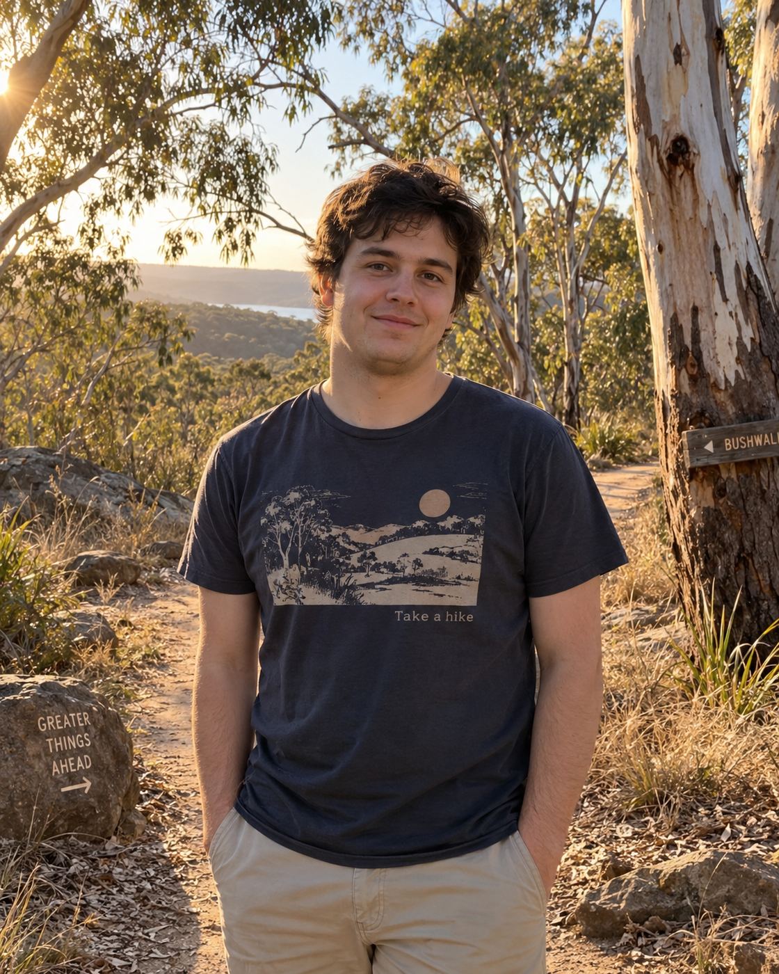 Illustrative portrait of a smiling man in a navy tee outdoors